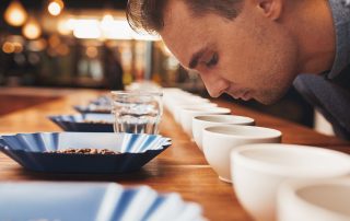 Man smelling aromatic coffee at a tasting